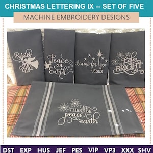 May include: Five gray kitchen towels with white embroidery. The towels feature Christmas-themed sayings, including "Rejoice", "Peace on Earth", "I came for you - Jesus", "Let there be peace on earth", and "All is calm, all is bright".