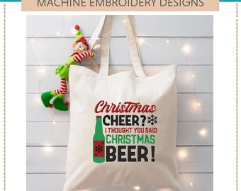 May include: Machine embroidery design for a tote bag featuring a green beer bottle with a red snowflake and the text "Christmas Cheer? I thought you said Christmas Beer!"