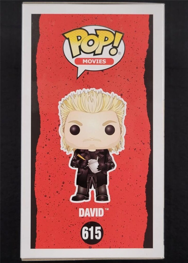 May include: Funko Pop! Movies figure of David from The Lost Boys. The figure has blonde hair and is wearing a black coat, holding a takeout container with chopsticks. The figure is on a red background with the Pop! Movies logo and the number 615.