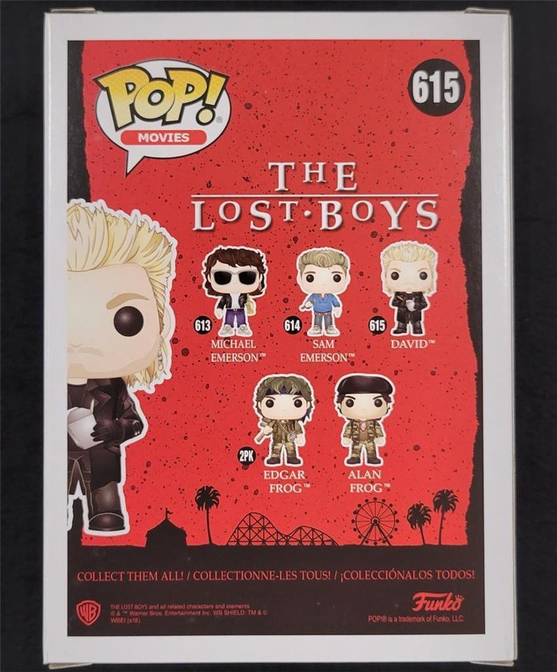 May include: Back of a Funko Pop! Movies box featuring characters from The Lost Boys. The box is red with white text and images of the characters. The characters include Michael Emerson, Sam Emerson, and David. The box also says "Collect them all!"