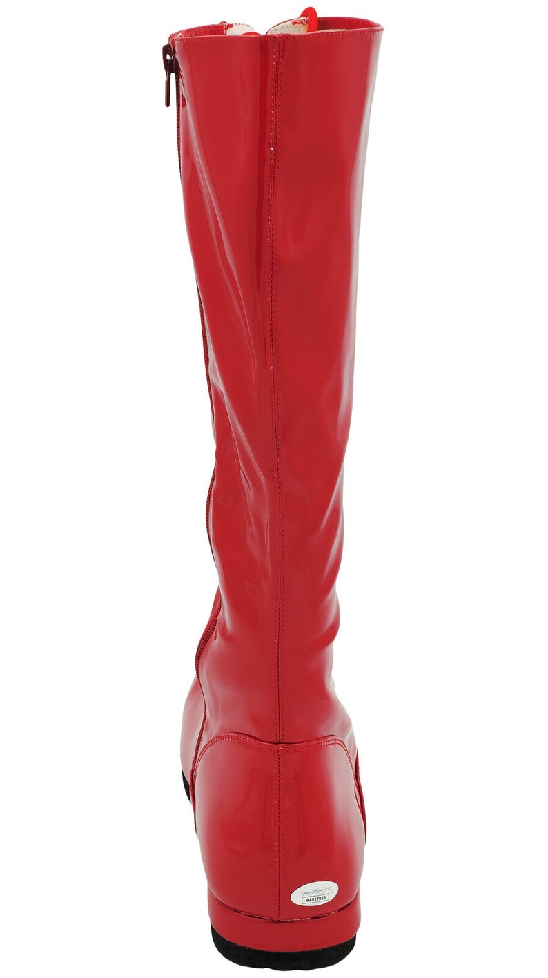 May include: Red knee-high boots with a zipper on the side and a black sole. The boots have a glossy finish and a signature on the back.
