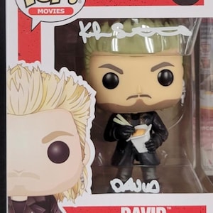 May include: A Funko Pop! vinyl figure of David from the movie "The Lost Boys." The figure is number 615 in the Pop! Movies series. David is depicted with green hair, a black coat, and is holding a takeout container with chopsticks. The box has the Pop! Movies logo.