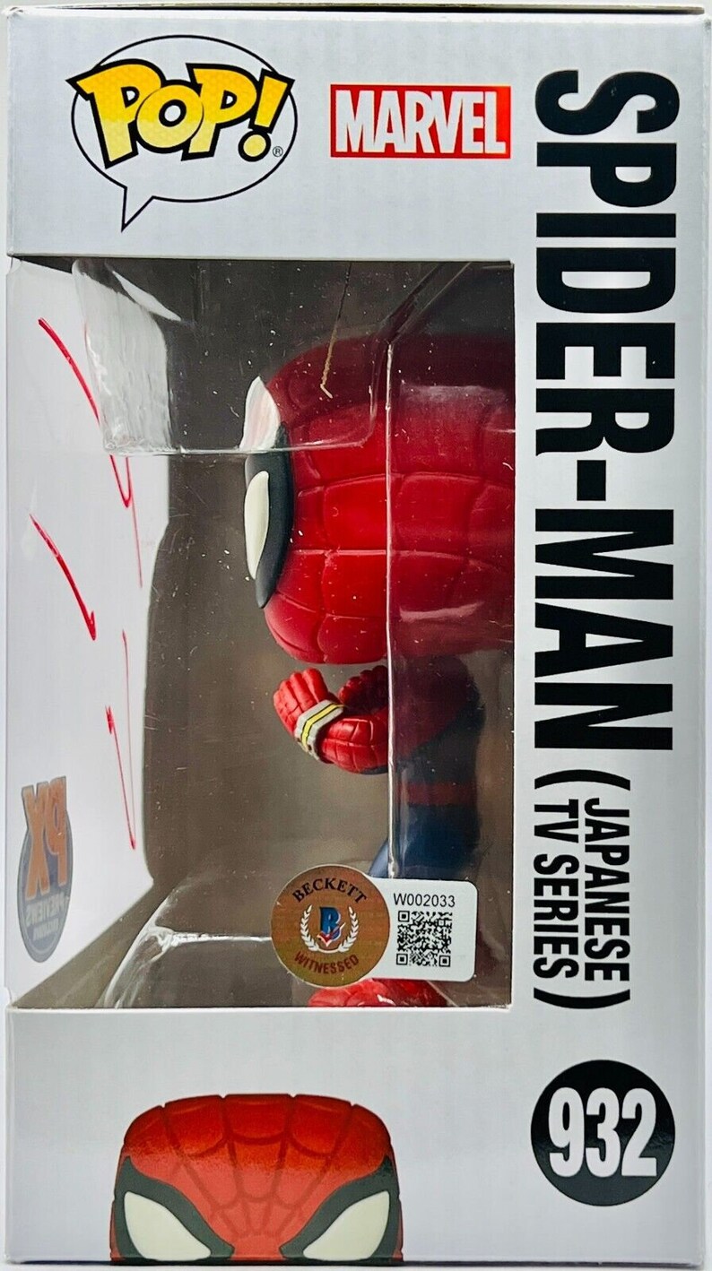 May include: A red and blue Spider-Man Pop! Vinyl figure in a box. The box has a white background with the words "Pop!" and "Marvel" in black. The figure is holding a web shooter in its right hand. The box also has a Beckett grading sticker with the number "W002033" and a QR code. The box has the text "Spider-Man (Japanese TV Series) 932" on the side.