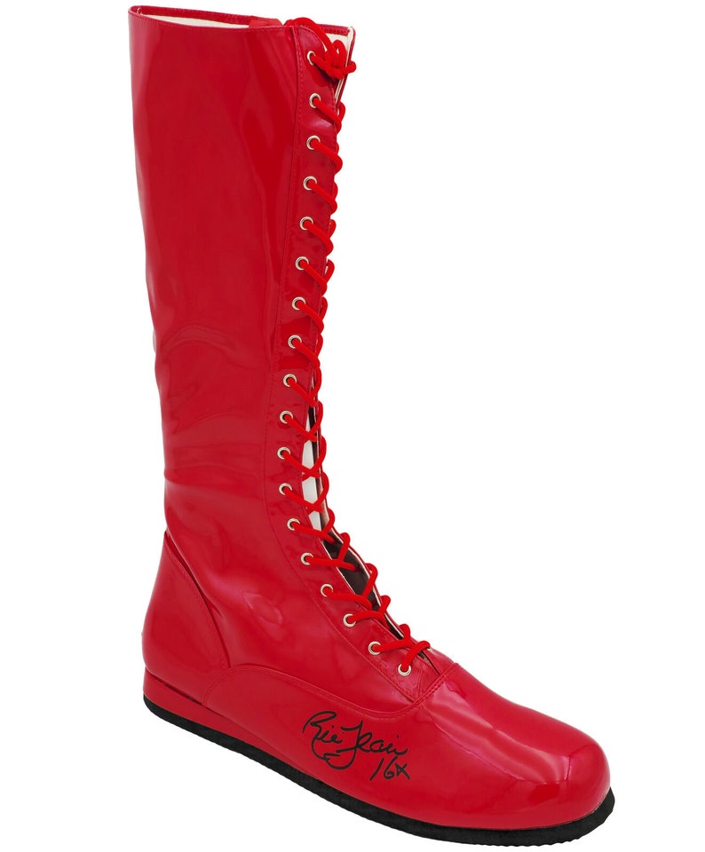 May include: Red leather wrestling boot with a black lace-up closure and a black signature on the sole. "Ric Flair 16x"
