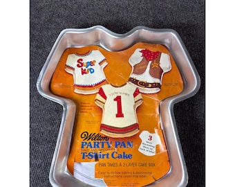 Molde para pastel Wilton Vintage 1979 con forma de camiseta, modelo 502-5617, de aluminio, fabricado en Corea.