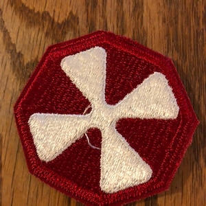 May include: A red octagonal patch with a white four-pointed star in the center.