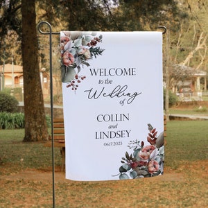 May include: A white wedding welcome sign with floral accents. The sign reads "Welcome to the Wedding of Collin and Lindsey 06.17.2023".