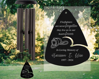 May include: Black metal wind chime with a triangular shaped charm that reads "Firefighters are never forgotten they live on in our hearts forever" and "In Loving Memory of Harrison E. Wise 1957-2024".