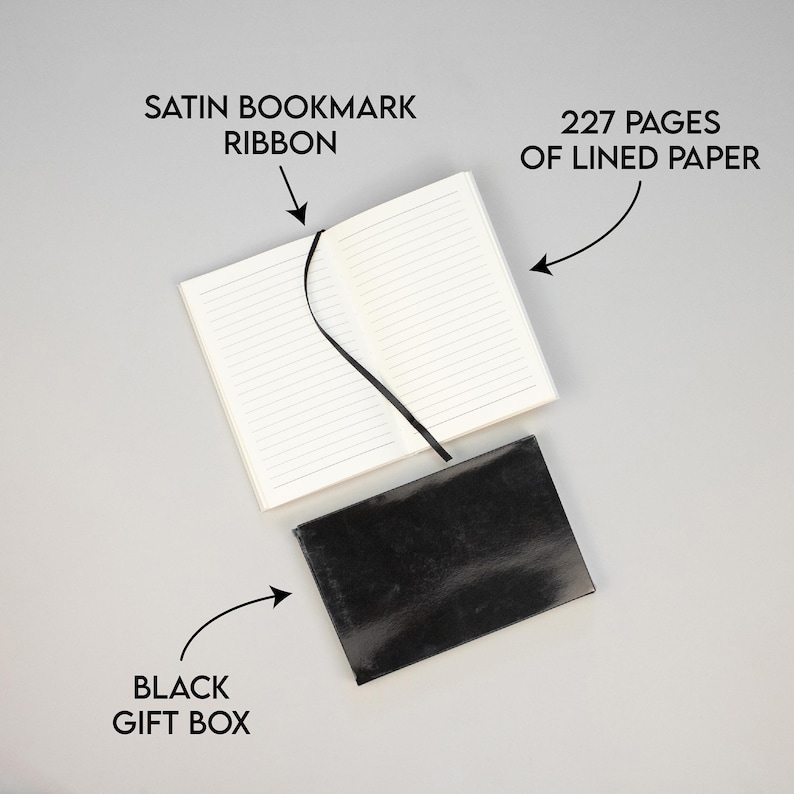 May include: A black gift box containing a white notebook. The notebook has 227 lined pages and a black satin ribbon bookmark.