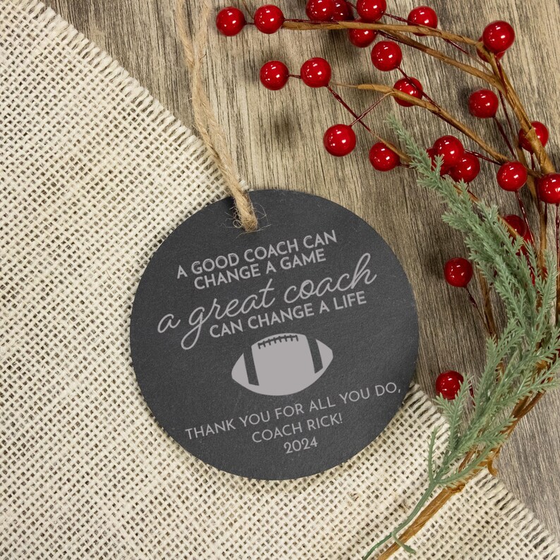 May include: A black chalkboard ornament with white text that reads "A good coach can change a game, a great coach can change a life."  The ornament also includes a football graphic and the text "Thank you for all you do, Coach Rick! 2024."