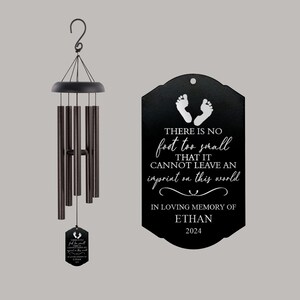 May include: Black wind chime with a metal tag that reads "There is no foot too small that it cannot leave an imprint on this world. In loving memory of Ethan 2024".