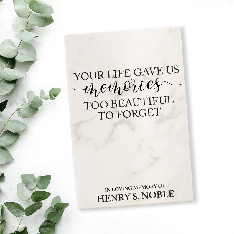 May include: A rectangular memorial plaque with a marble-like pattern. The text "YOUR LIFE GAVE US memories TOO BEAUTIFUL TO FORGET" is displayed in black script. The bottom of the plaque reads "IN LOVING MEMORY OF HENRY S. NOBLE".