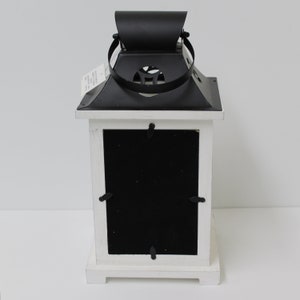 Personalized son memorial lantern picture frame that reads Son our hearts still ache in sadness and secret tears still flow and is personalized with names and relationship. Includes LED candle with automatic timer and handle on top.