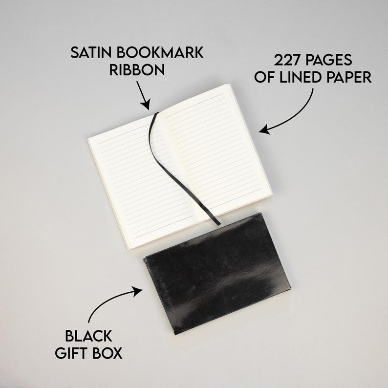 May include: A black gift box with a white notebook inside. The notebook has 227 lined pages and a black satin ribbon bookmark.