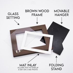 May include: A brown wood picture frame with a glass setting, a white mat inlay, a movable hanger, and a folding stand. The mat inlay allows you to display a 5x7 or a 4x6 photo.