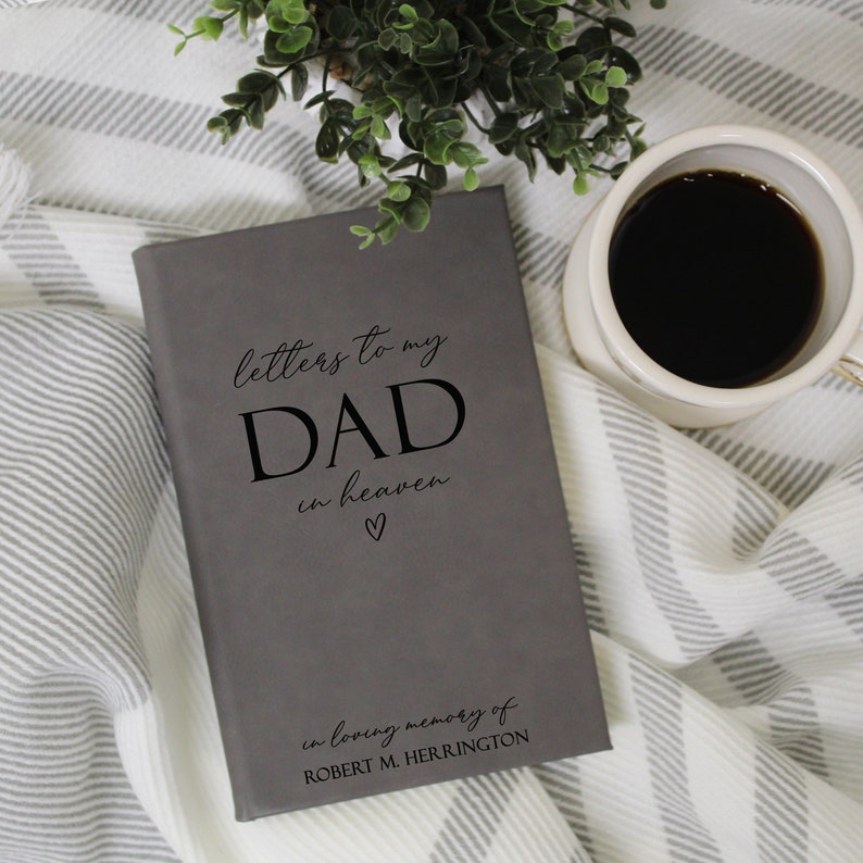 Może przedstawiać: Szary dziennik z tekstem "letters to my DAD in heaven" i małym symbolem serca. Pod tekstem widnieje napis "in loving memory of ROBERT M. HERRINGTON".
