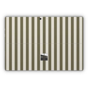 May include: A white and olive green striped tablet skin with a black Microsoft logo.