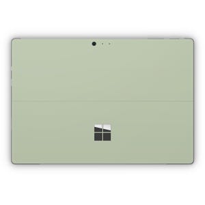 Può includere: Un tablet computer di colore verde chiaro con un logo Microsoft nero sul retro.