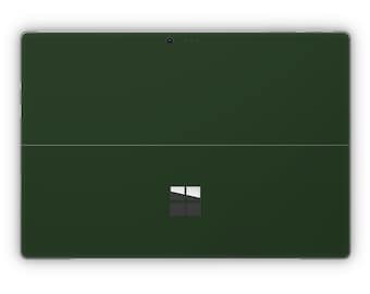 May include: A dark green Microsoft Surface Pro tablet with a white Microsoft logo on the back.