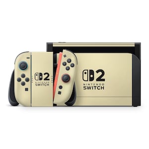 May include: A cream-coloured Nintendo Switch console and two Joy-Con controllers. The console and controllers display the Nintendo Switch logo and text. The right controller has a coral-coloured side.