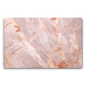 May include: Pink marble laptop skin with the word "ASUS" in silver lettering.