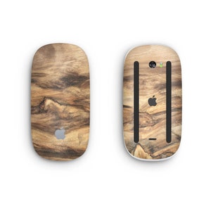 May include: A wooden-patterned skin for a wireless mouse. The skin features a dark brown wood grain pattern with lighter brown streaks. The Apple logo is visible on the top of the mouse.