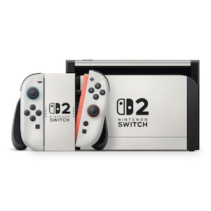 May include: A white Nintendo Switch console with matching Joy-Con controllers. The controllers have blue and red accents, with black buttons and joysticks. The console and controllers feature the Nintendo Switch logo.