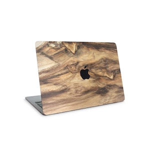 a laptop with a wood grain texture on the cover, which is a natural and organic pattern.