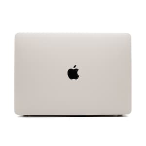 May include: A closed silver laptop computer with the Apple logo on the lid.