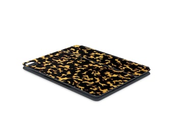 May include: A black and brown patterned iPad case with a fold-over flap.