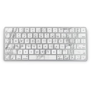 May include: A silver computer keyboard with white marble-patterned keycaps. The keyboard has standard keys, including function keys, number keys, and a space bar. The keys are labeled with black text.