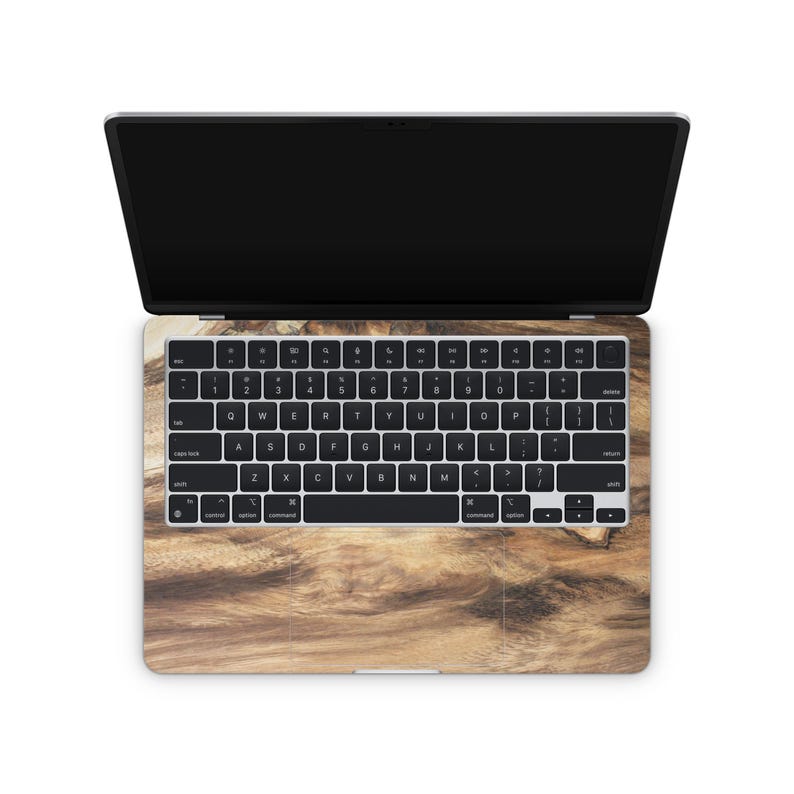 an open laptop with a wood grain-patterned keyboard cover.