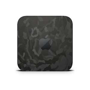 May include: A black Mac mini computer with a camouflage pattern. The Apple logo is visible on the front of the device.
