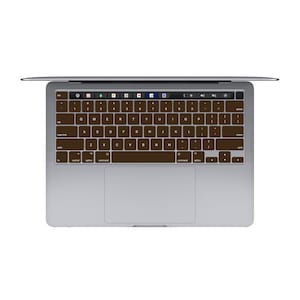 May include: A silver laptop computer with a brown keyboard. The keyboard has the standard layout with letters, numbers, and symbols.