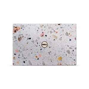 May include: A white laptop with a terrazzo pattern and a Dell logo in the centre.