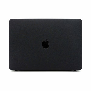May include: A black laptop computer with a silver Apple logo on the lid.