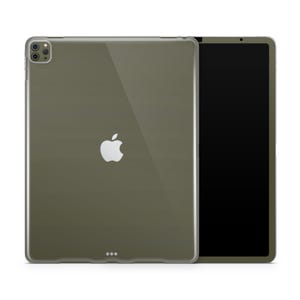 May include: An olive-green iPad Pro with a clear protective case. The case has a transparent design, showcasing the Apple logo. The iPad's screen is black, and the case has a camera cutout and three small dots at the bottom.