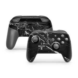 May include: Black and white marble patterned Nintendo Switch controller. The controller has a black and white marble design with a black background and white veins.