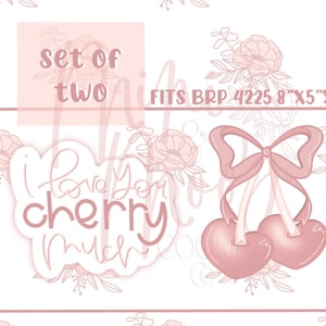 Puede incluir: Conjunto de dos cortadores de galletas rosas, uno con forma de cereza con un lazo y el otro con forma de nube con el texto "Te quiero mucho cereza".