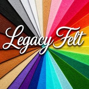 May include: A colourful arrangement of Legacy Felt sheets, fanned out to display a wide range of hues. The image features felt in shades from dark brown and black to bright pinks, greens, and blues. The words "Legacy Felt" are written in white script.