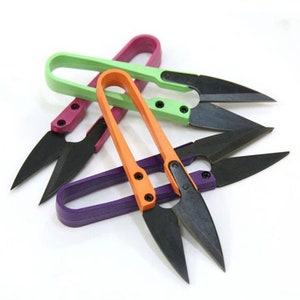 May include: Four pairs of colourful thread snips with black blades. The snips are made of plastic and have a comfortable grip.