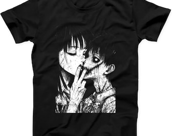 May include: A black short-sleeve t-shirt featuring a high-contrast white graphic print of two figures in a close embrace. The illustration depicts a person with long dark hair and a person with a stitched, distorted face, rendered in a gritty, ink-like style.