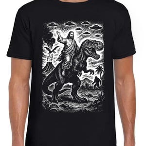 Jesus Riding Dinosaur UFO Bigfoot Volcano Sketch Weird Humorous Hilarious Witty Funny Music Black Gift Tee T Shirt 440
