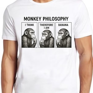 May include: White t-shirt with the text "MONKEY PHILOSOPHY" above three black and white illustrations of monkeys. The illustrations are in boxes with the text "I THINK", "THEREFORE I AM", and "BANANA".