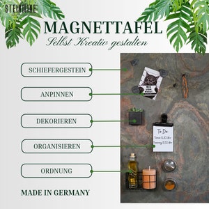 May include: A slate magnetic board with the text "MAGNETTAFEL Selbst Kreativ gestalten" in German. The board is decorated with various items, including a potted succulent, a to-do list, a small cat picture, and a few other items. The text "SCHIEFERGESTEIN ANPINNEN DEKORIEREN ORGANISIEREN ORDNUNG MADE IN GERMANY" is printed on the left side of the board.