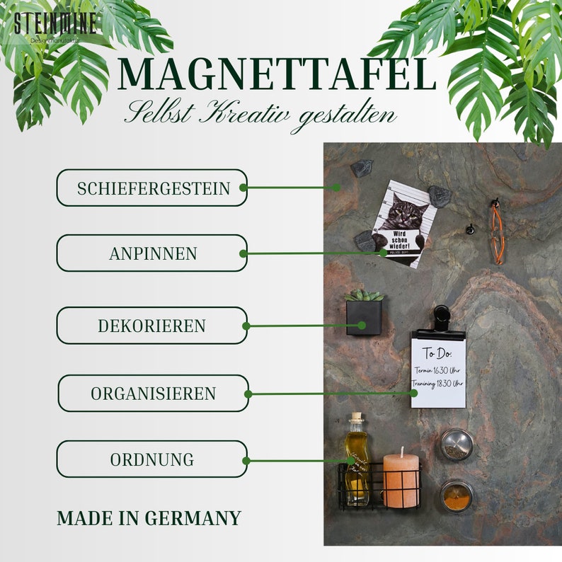 May include: A slate magnetic board with the text "MAGNETTAFEL Selbst Kreativ gestalten" in German. The board is decorated with various items, including a potted succulent, a to-do list, a small cat picture, and a few other items. The text "SCHIEFERGESTEIN ANPINNEN DEKORIEREN ORGANISIEREN ORDNUNG MADE IN GERMANY" is printed on the left side of the board.