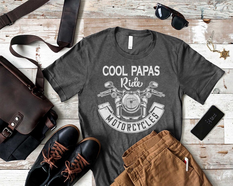May include: A gray t-shirt with a white graphic of a motorcycle and the text "Cool Papas Ride Motorcycles".