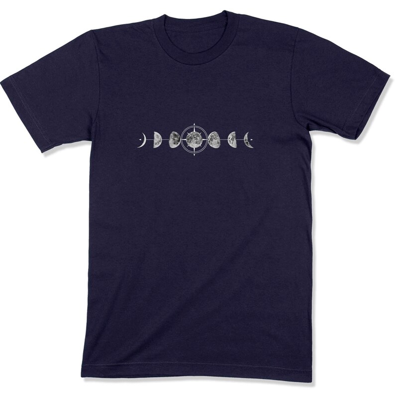 May include: A navy blue t-shirt with a graphic of the moon phases in various stages, centered around a compass.