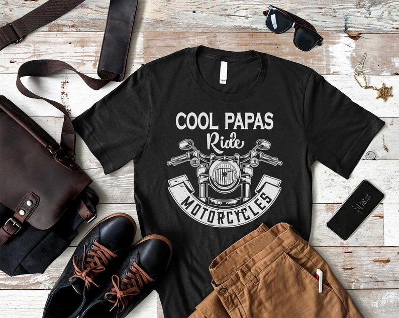May include: Black t-shirt with a white graphic of a motorcycle and the text "Cool Papas Ride Motorcycles".