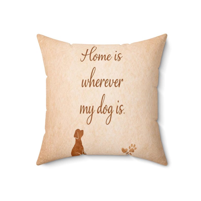 May include: A square throw pillow with a light tan, textured background. The text "Home is wherever my dog is." is printed in dark brown script. Below the text, a small brown silhouette of a dog sits next to a brown paw print icon.
